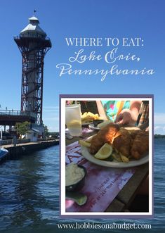 there is a plate of food on the table next to the water and a light house