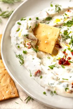 a white plate topped with cheese and crackers