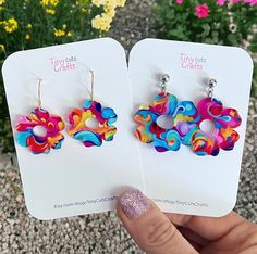 Colorful Groovy Flower Earrings. Crafted from high-quality patterned acrylic, these earrings are wonderfully lightweight. Choose from two sizes: Small, with a 1" diameter flower, or Large, with a 1.25" diameter flower. Designed for comfort, these earrings feature hypoallergenic stainless steel findings, making them gentle on even the most sensitive ears. Their lightweight construction ensures you can wear them joyfully throughout the day, effortlessly adding a touch of flair to any outfit withou Trendy Flower Earrings As Gift, Trendy Summer Flower Charm Earrings, Trendy Multicolor Dangle Flower Earrings, Trendy Multicolor Flower Earrings For Summer, Playful Handmade Multicolor Flower Earrings, Playful Multicolor Handmade Flower Earrings, Playful Multicolor Flower Earrings As Gift, Colorful Earrings As Spring Gift, Colorful Spring Gift Earrings