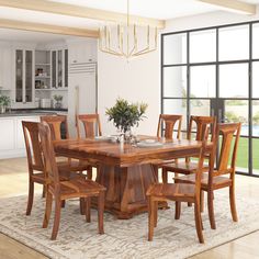 a dining room table with chairs and a potted plant