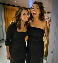 two women standing next to each other in front of a mirror with their mouths open