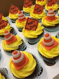 cupcakes decorated with yellow frosting and orange icing are arranged in rows