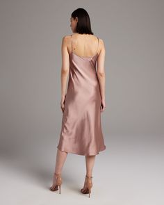 Bias cut Midi Slip Dress elegantly drapes on the body. This perfect basic can be worn for life, dressed up, or dressed down, for the perfect ensemble. Style with a sweater and boots in the Fall or wear with sandals in the Summer. 100% Silk Charmeuse Made in New York City Product Care: Dry Clean Only