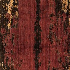 an old red rug with black and brown stripes on the bottom, in front of a white background