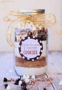 a glass jar filled with cookies and marshmallows