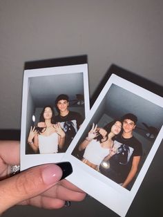 two polaroid photos being held in front of the camera