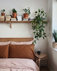 a bed with two plants on top of it