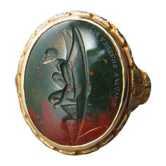 This exquisite intaglio is masterfully engraved onto bloodstone (heliotrope) and features a Gargoyle. The stone is set in an 18K gold signet ring and surrounded by 18 VS GH diamonds. Production time for this piece is 12 weeks Can be made in any size ranging from 6-12. Chavdar Chushev is an artist, restorer, jeweler, and master of the ancient art of gem carving. His extensive knowledge of gemstones and precious metals is complimented by a familiarity with more unusual materials, such as exotic wo Signet Ring With Diamond, Gem Carving, Rings Signet, Gold Finger Rings, Diamond Signet Ring, Art Ancien, Signet Rings, Gold Signet Ring, Dope Jewelry