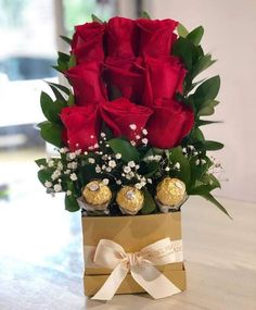 a box filled with chocolates and roses on top of a table