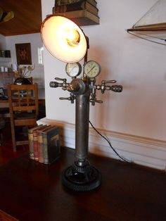 a lamp that is on top of a wooden table in a room with books and other items