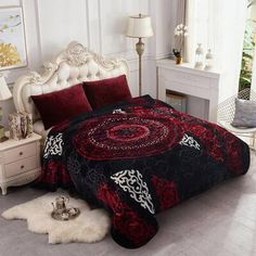 a bed covered in a red and black comforter