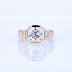 an old mine cut diamond ring with baguets in yellow gold and white diamonds