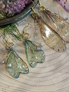 Handcrafted resin and acetate wings with twisted wire and glass beads, glitter and rhinestone accents Fairy Wing Earrings, Twisted Wire, Fairy Wings, Wing Earrings, Glass Beads, Glitter, Pendant Necklace, Drop Earrings, Beads