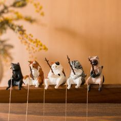 small figurines are lined up on a shelf