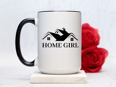 a black and white coffee mug with the words home girl on it next to red roses