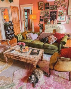 a living room filled with lots of furniture and pictures on the wall above it's coffee table