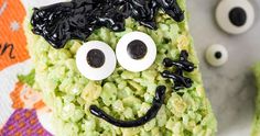 a cake decorated to look like a monster with googly eyes and black hair on it