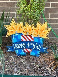 a happy 4th birthday sign in front of a brick wall with trees and bushes behind it