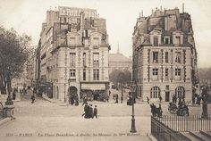 an old black and white photo of people walking in front of tall buildings on a city street