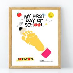 a framed poster with the words, my first day of school and a hand holding an apple