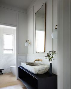 a bathroom with two sinks and a large mirror