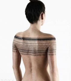 the back of a woman's body with an intricate design on it