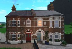 an image of a large brick house with lots of windows on the front and side