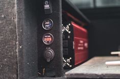 an electronic device is shown in the back of a vehicle's cab door, with two dials on each panel