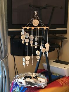 a metal tray with coins hanging from it next to a flat screen tv mounted on the wall