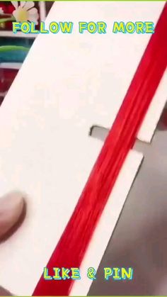 someone is making a cross out of paper with red tape on it and the words follow for more like & pin