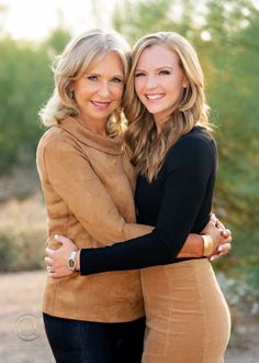 two women hugging each other in the desert