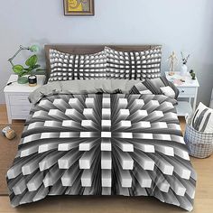 an image of a bed set with grey and white designs on it in a bedroom