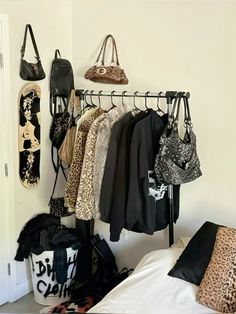 there are many bags and purses hanging on the wall