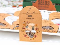 there are many seed packets on the table with flowers and leaves around them that say let love grow