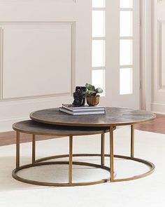 two coffee tables sitting on top of each other in front of a white wall and floor