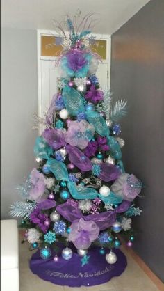 a decorated christmas tree with purple and blue decorations