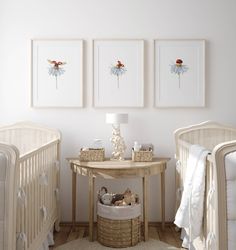 a baby's room with two cribs and three pictures on the wall