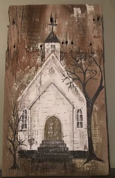 an old church painted on wood with trees and branches in the foreground, against a white wall