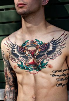 a shirtless man with tattoos on his chest