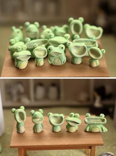 there are many small green frog figurines sitting on a wooden table and in front of each other