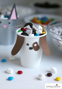 a cup filled with marshmallows and dog shaped candies