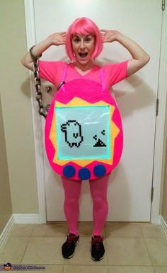 a woman dressed as a pink monster holding a sign