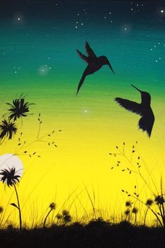 two birds are flying in the sky above some tall grass and flowers at night time