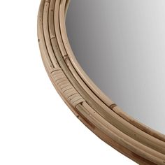 a round mirror made out of bamboo with curved ends on an isolated white background,