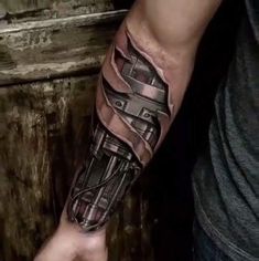 a man's arm with a black and grey tattoo design on his left arm