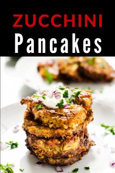 zucchini pancakes stacked on top of each other with sour cream and chopped red onions