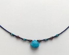 ❘❘❙❙❚❚ ON SALE ❚❚❙❙❘❘ This is a very fine delicate semi precious necklace made with Turquoise teardrop stone, Lapis lazuli beads and touch of faceted 3mm Garnet, oxidised silver and Turquoise beads.Turquoise teardrop is 10x10mm size.Please take a look at all the photos and ask any questions you might have.The necklace is short but not quite a choker - it sits just under the collar bones.The full measurement from clasp to end is 44cm or 17.5 inches.All the jewellery comes in Heiter branded boxes. Gift Blue Drop Necklace With Natural Stones, Bohemian Briolette Beaded Necklace For Gift, Bohemian Briolette Beaded Necklace Gift, Bohemian Faceted Beaded Necklaces For Gifts, Turquoise Teardrop Faceted Beads Jewelry, Bohemian Faceted Beaded Necklace For Gift, Artisan Teardrop Gemstone Beads Necklace, Bohemian Blue Briolette Jewelry, Bohemian Faceted Turquoise Beaded Necklaces