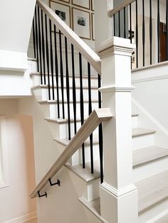 Balusters are the decorative vertical members of a balustrade system. Our ornamental iron balusters offer an extensive assortment of popular styles in various square and round sizes ranging from 1/2-in up to 3/4-in. They are constructed from "mild" steel, making them very durable and much stronger than wrought iron versions. Each and every baluster is handmade, which means no two are exactly alike; the slight variations in the details add exceptional character to any stairway. Our iron balusters Stair Railing In Living Room, Diy Staircase Remodel, Transitional Railings For Stairs, Metal Balusters Staircase, Oak Stairs With Iron Spindles, Indoor Metal Stair Railings, White Railing With Black Spindles, White Stair Railing Ideas, Black And White Stair Railing