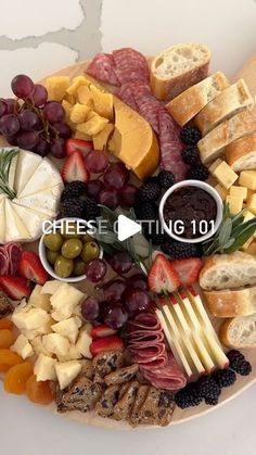 a platter filled with cheeses, meats and fruit