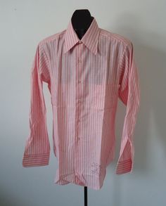 "vintage MEN's 70s big collar striped shirt  button front,   3 1/2\" collar,  selvedge front facing, chest pocket, slight taper,   shirt tail hem   LABEL - VAN HEUSEN CENTURY        prob. USA 75% Polyester / 25% COTTON PINK & WHITE WOVEN STRIPE      condition -  NOS,  NEW-OLD-STOCK,  UNWORN   SIZE   15 - 33   (M)  chest (side - side ) 22 inches  across back shoulders 17 inches  sleeve length -  33 (24 inches from shoulder)    length (back neck to hem) 31 inches" Semi-formal Striped Collared Shirt, Spring Business Shirt With Vertical Stripes, Striped Dress Shirt With Spread Collar For Spring, Spring Formal Shirt With Vertical Stripes, Semi-formal Shirt With Striped Collar For Spring, Spring Striped Dress Shirt With Spread Collar, Fitted Dress Shirt With Striped Collar, Pinstripe Collared Shirt, Striped Semi-formal Collared Shirt